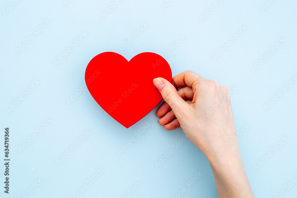 Medical insurance concept with red heart in female hands, top view Medical insurance concept with red heart in female hands, top view