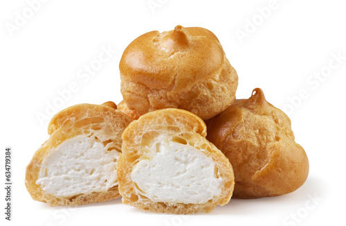 Photos Pile of profiteroles and halves on a white background. Isolated