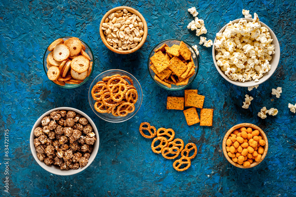 Many bowls of snacks for party - chips popcorn and nuts Many bowls of snacks for party - chips popcorn and nuts