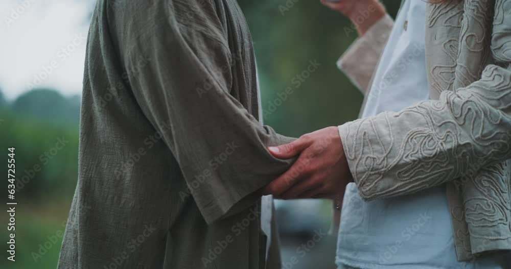 Close up of a queer couple holding each others arms. Close up of a queer couple holding each others arms.