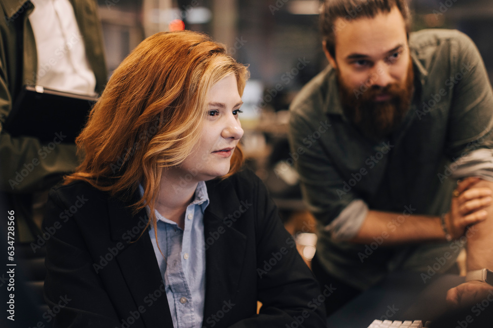 Businesswoman and businessman staring at office Businesswoman and businessman staring at office