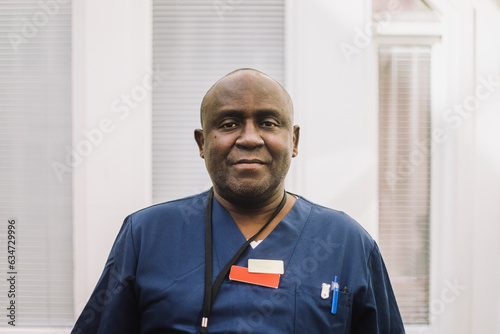 Portrait of mature male doctor with shaved head at hospital photo