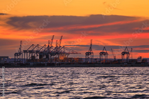 Amazing sunset over the container terminal at Baltic Sea in Gdansk, Poland