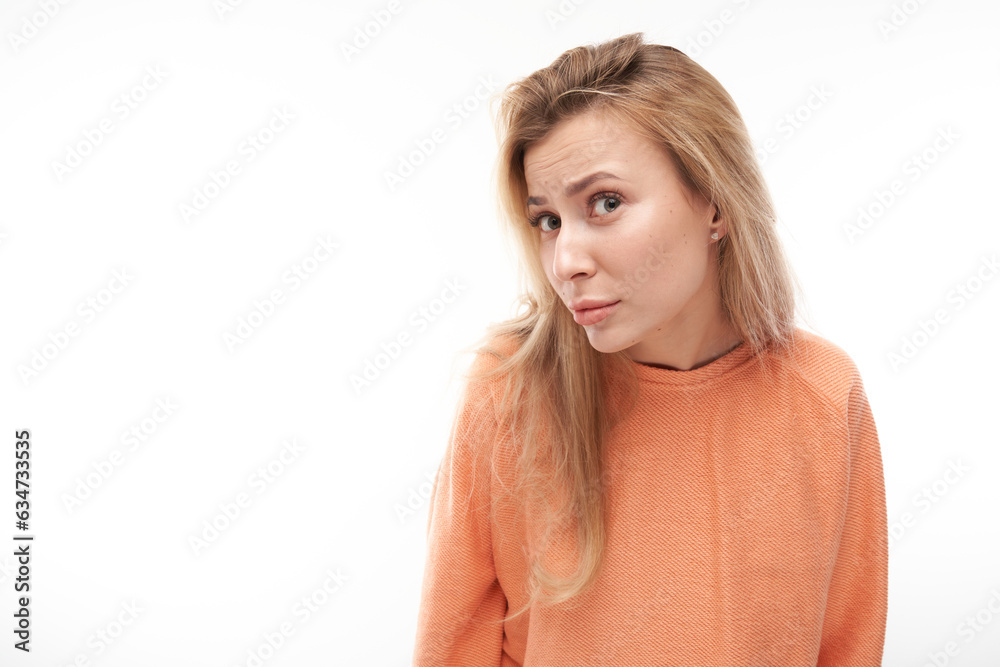 Portrait of young blond girl suspiciously looking at camera isolated on white studio background, squinting incredulously. Portrait of young blond girl suspiciously looking at camera isolated on white studio background, squinting incredulously.