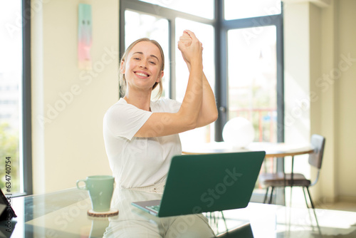caucasian pretty woman with a laptop feeling happy, surprised and proud, shouting and celebrating success with a big smile