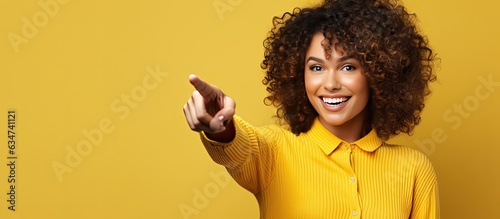 Happy woman pointing and smiling offering advertisement space