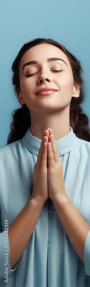 Young woman hoping for an unexpected surprise praying with hands held together expressing positive feelings Young woman hoping for an unexpected surprise praying with hands held together expressing positive feelings