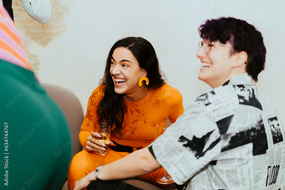 © Maskot - Happy business colleagues laughing while sitting together during event at convention center