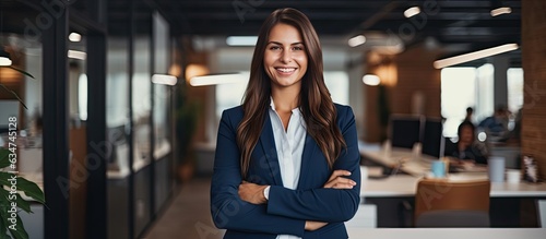 Smiling Caucasian woman manager in suit with folded arms surveys open area in contemporary office Professional lifestyle occupation advertisement and oppo