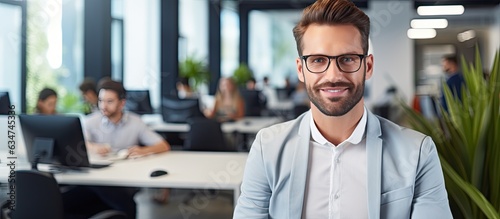 Male HR manager in modern office smiling at camera welcoming recruitment