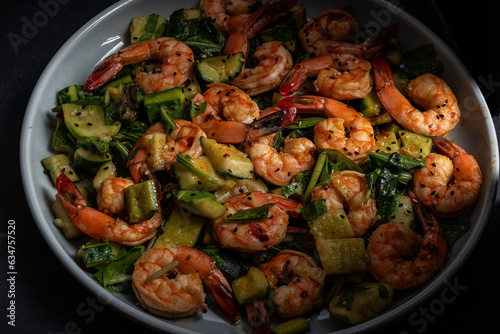 Smashed cucumber salad with shrimp and chopped lettuce greens. Dressed with soy sauce, rice wine vinegar, sesame oil, and chili crisp,