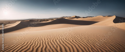 Landscape of golden dune against blue sky. Wide angle shot. Desert scene.
