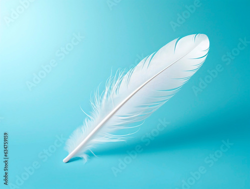 White feather on blue background, soft focus and beautiful bokeh