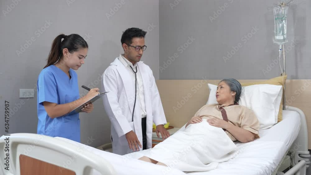 Young Asian doctor and nurse supports an elderly patient in hospital ward. Young Asian doctor and nurse supports an elderly patient in hospital ward.
