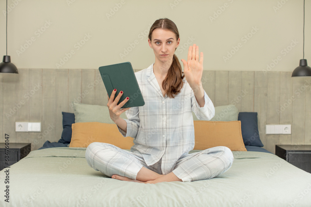 looking serious showing open palm making stop gesture. bed time concept looking serious showing open palm making stop gesture. bed time concept