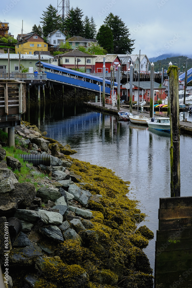 Old wooden Fishermen pier for fishing boats in Ketchikan, Alaska with sailing boats, marina, yacht harbor and sea lions