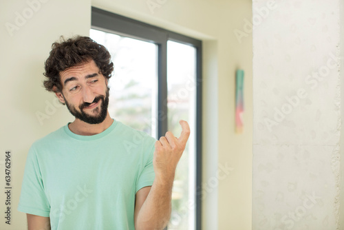 young crazy bearded man feeling happy, successful and confident, facing a challenge and saying bring it on! or welcoming you