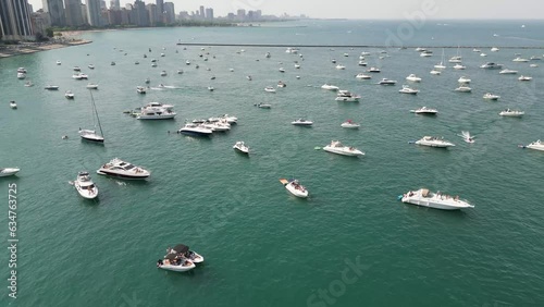 Drone Footage of Chicago skyline and lakefront with busy traffic and boats on a warm summer day