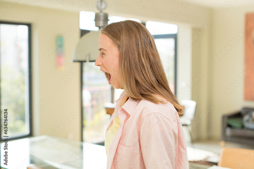 pretty blond woman shouting aggressively, looking very angry, frustrated, outraged or annoyed, screaming no pretty blond woman shouting aggressively, looking very angry, frustrated, outraged or annoyed, screaming no