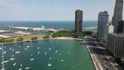 Drone Footage of Chicago skyline and lakefront with busy traffic and boats on a warm summer day