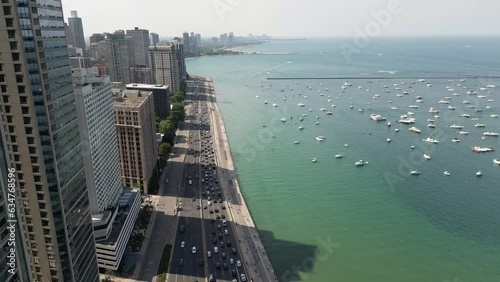 Drone Footage of Chicago skyline and lakefront with busy traffic and boats on a warm summer day