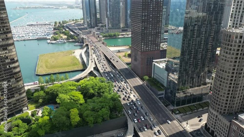 Drone Footage of Chicago skyline and lakefront with busy traffic and boats on a warm summer day