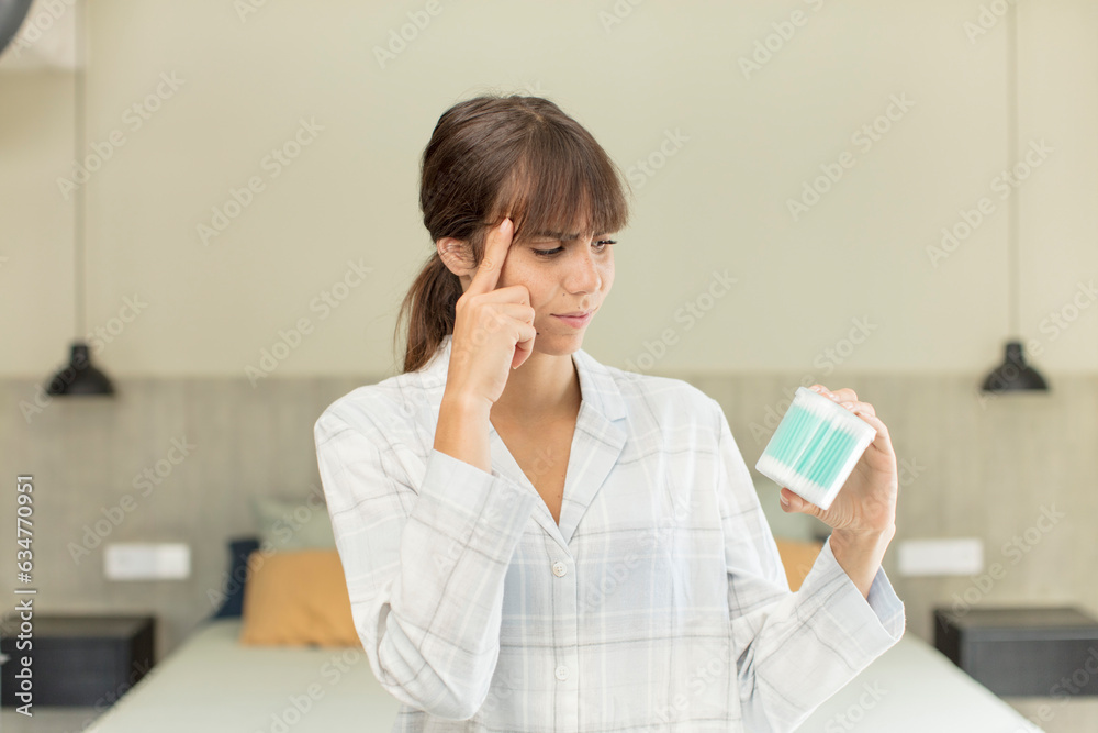 young pretty woman looking surprised, realizing a new thought, idea or concept ear bud concept young pretty woman looking surprised, realizing a new thought, idea or concept ear bud concept