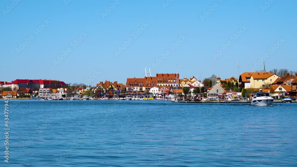 Mikolajki, Poland 22 04 2023: Cityscape of Mikolajki with yacht on Mikolajskie Lake. Poland Mikolajki, Poland 22 04 2023: Cityscape of Mikolajki with yacht on Mikolajskie Lake. Poland