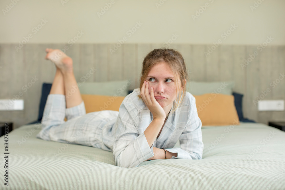 young pretty woman feeling bored, frustrated and sleepy after a tiresome. nightwear concept young pretty woman feeling bored, frustrated and sleepy after a tiresome. nightwear concept