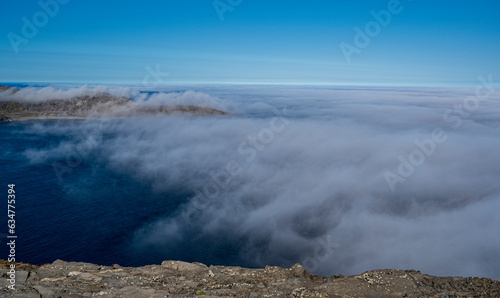 Beautiful view from the North Cape of the rocky cliffs and blue water of partly cloudy Barents Sea