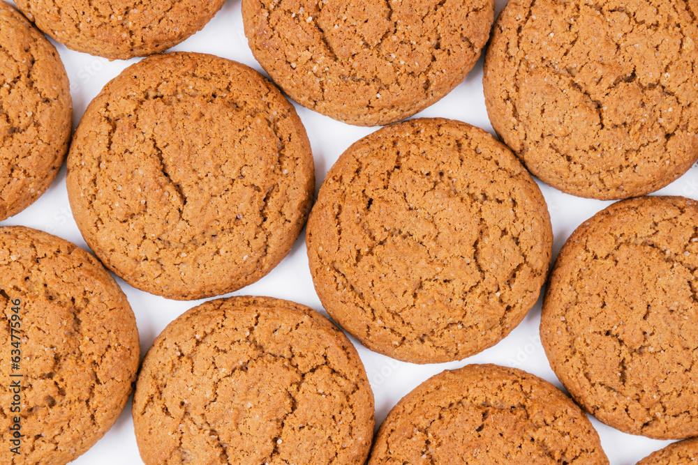Sweet tasty oatmeal cookies on white background. Top view, food pattern.