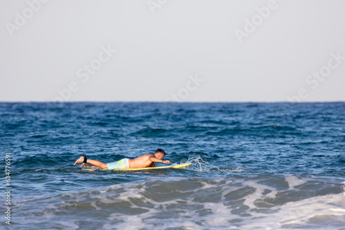 man swimming on the surfboard