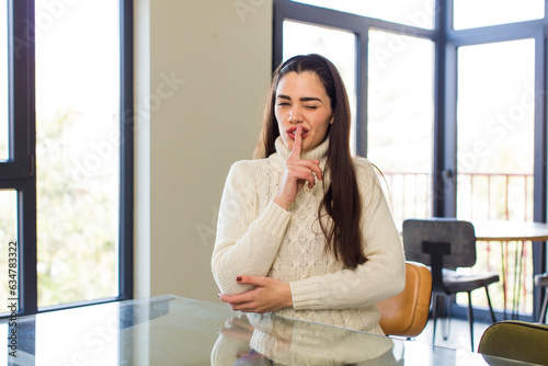 pretty caucasian woman looking serious and cross with finger pressed to lips demanding silence or quiet, keeping a secret Free Download pretty caucasian woman looking serious and cross with finger pressed to lips demanding silence or quiet, keeping a secret - GFXLoad