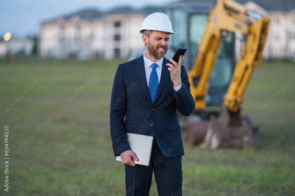 Worker in suit and helmet. Investor civil engineer, construction manager. Construction building developer at a construction site. Successful architect. Handsome hispanic builder man in suit. Worker in suit and helmet. Investor civil engineer, construction manager. Construction building developer at a construction site. Successful architect. Handsome hispanic builder man in suit.