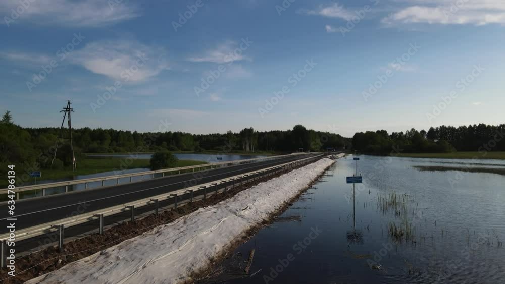A long road in the middle of a pond in the summer A long road in the middle of a pond in the summer