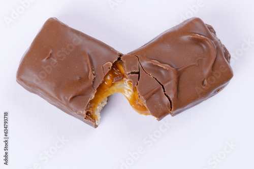 Chocolate bar with caramel fillings. Sweet chocolate bar broken into two pieces. Top view.