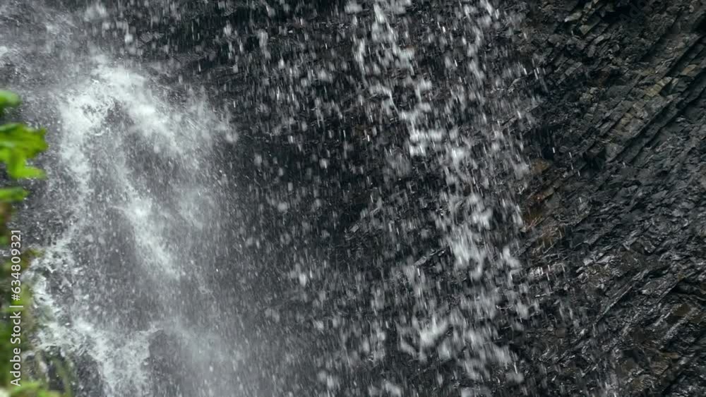 Close-up of water falls in forest. Slow Motion Natural background. Peaceful environment Close-up of water falls in forest. Slow Motion Natural background. Peaceful environment