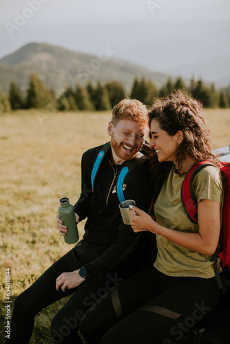 Young couple relaxing by a ...