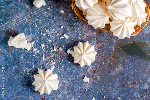 Small white meringues on a colored background