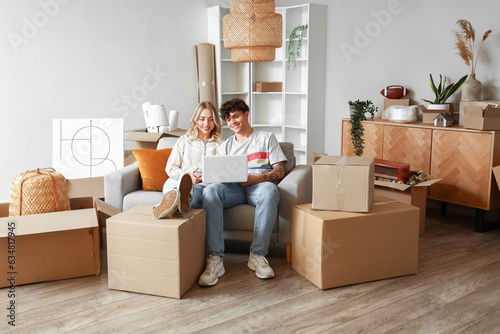 Young couple using laptop i...