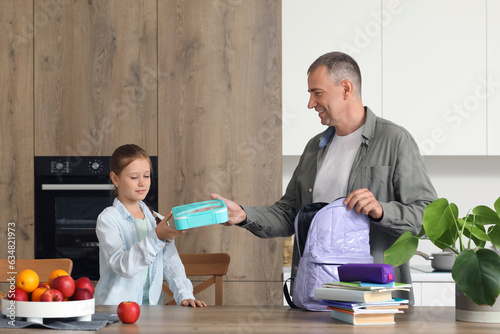 Father helping his little d...