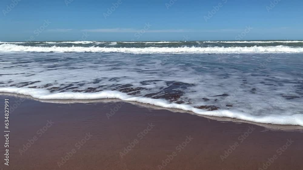 View of the sea waves crashing on the seashore of the beach. View of the sea waves crashing on the seashore of the beach.