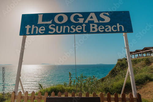 Logas the sunset beach signboard in front of ocean photo