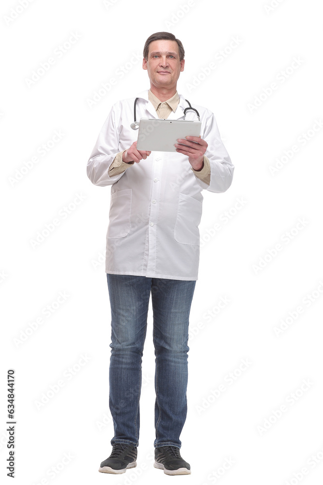 Front view of serious doctor working on a digital tablet
