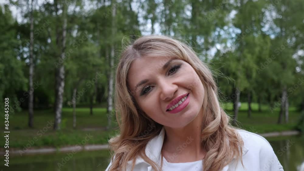 Cute forty year old woman smiling portrait in summer park 4k Cute forty year old woman smiling portrait in summer park 4k