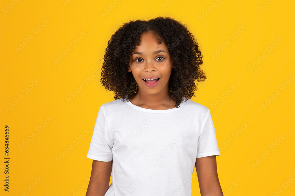 Happy shocked adolescent black girl in white t-shirt with open mouth
