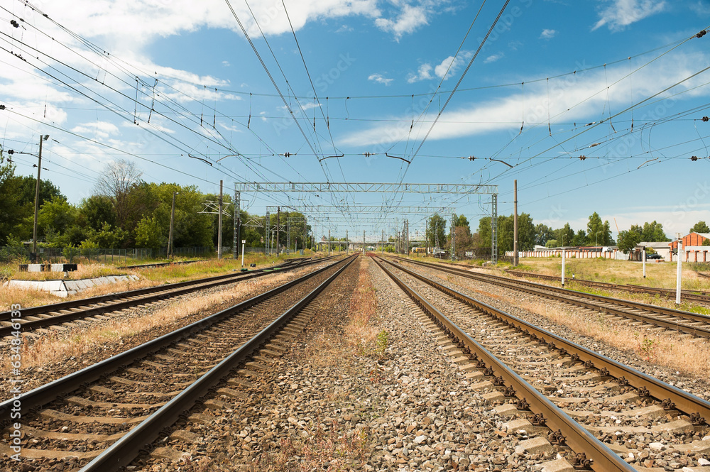 railway, in the photo rails against the background of a blue sky and clouds