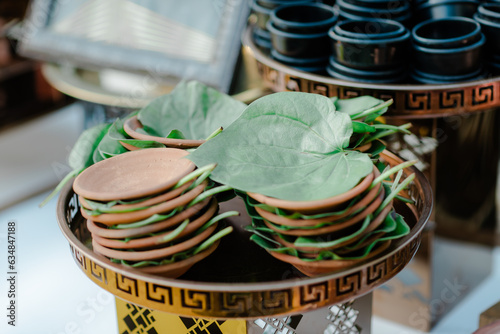 Paan is a preparation combining betel leaf with areca nut widely consumed throughout Southeast Asia, East Asia, and the Indian subcontinent. photo