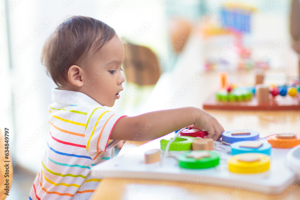 Fototapeta premium Cute baby boy in kindergarten or daycare.