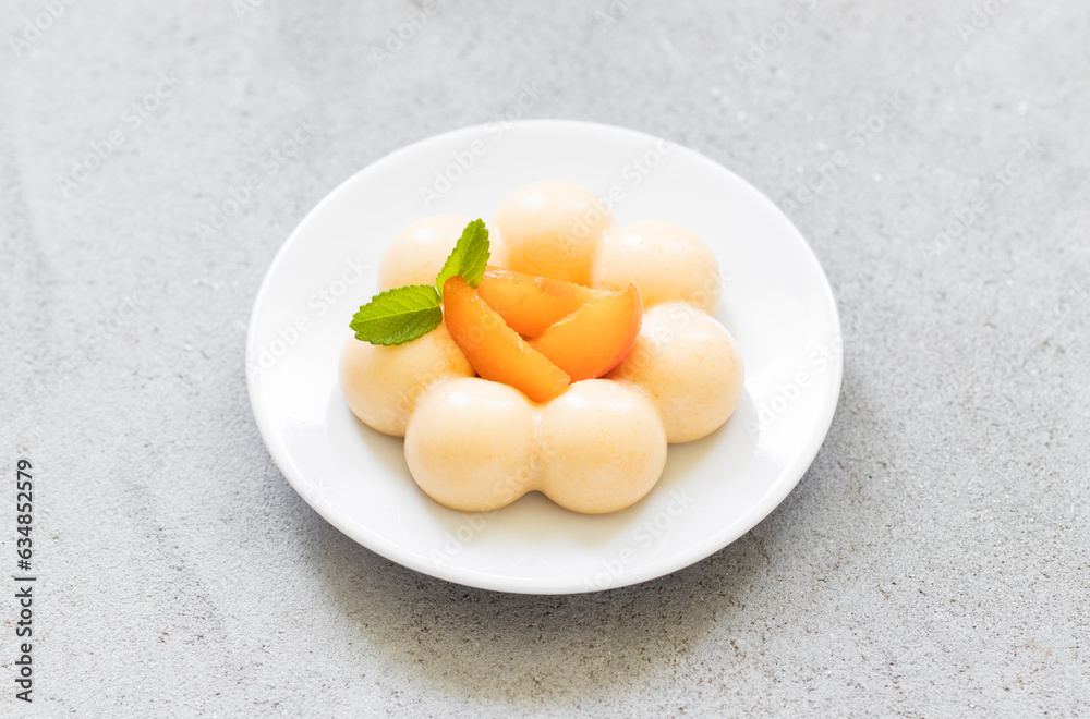 Apricot cream dessert, Panna Cotta in the shape of truffles, decorated with fresh apricot slices. Top view Apricot cream dessert, Panna Cotta in the shape of truffles, decorated with fresh apricot slices. Top view
